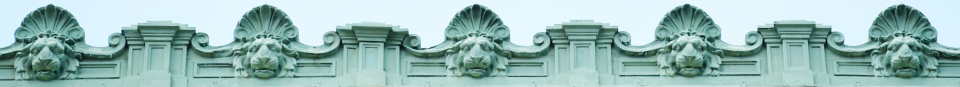 Columbia University campus architecture featuring lion head mascot. 
