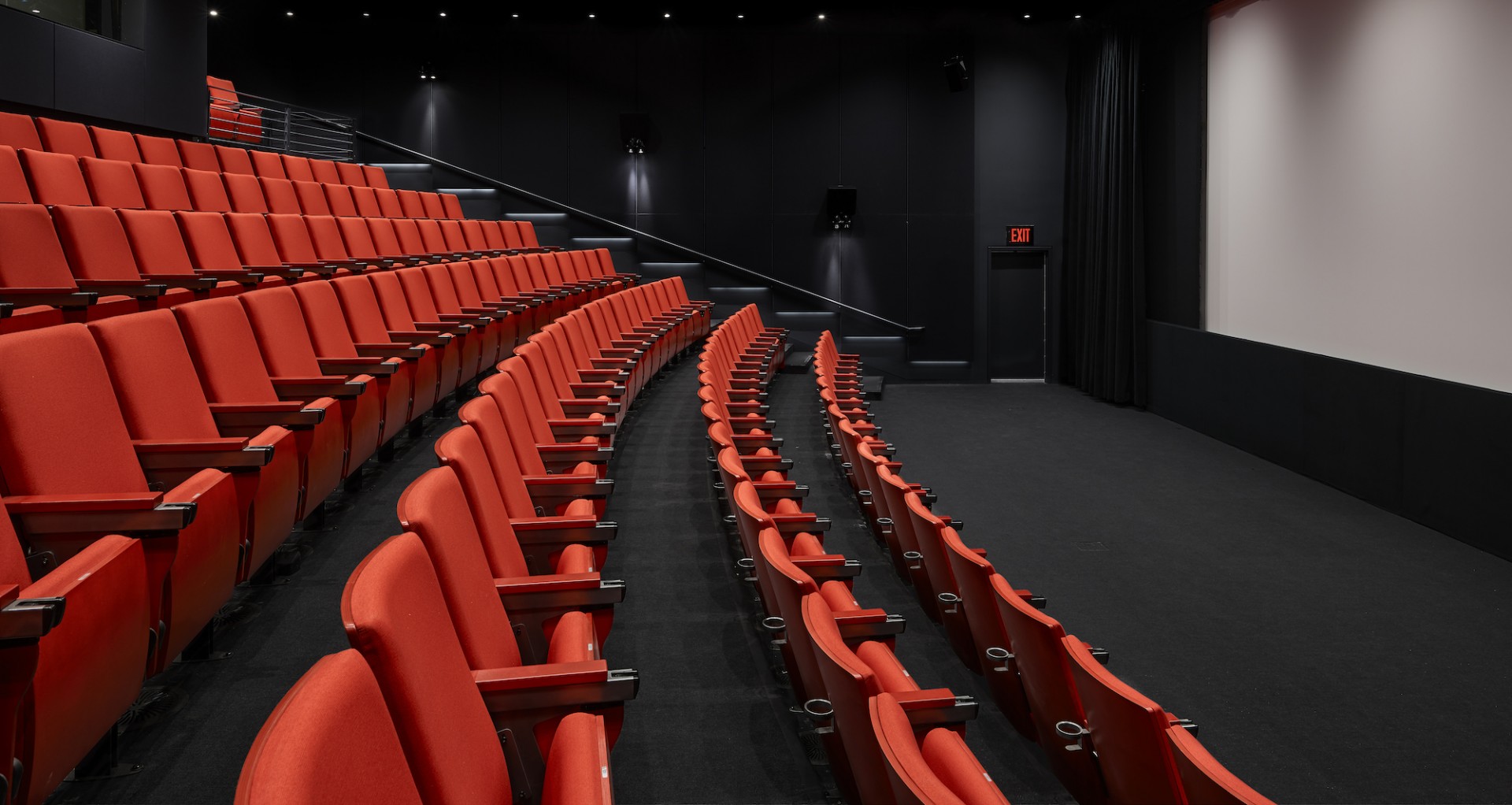Image of Lenfest Center for the Arts screening room with red stadium-seating chairs and a blank screen.