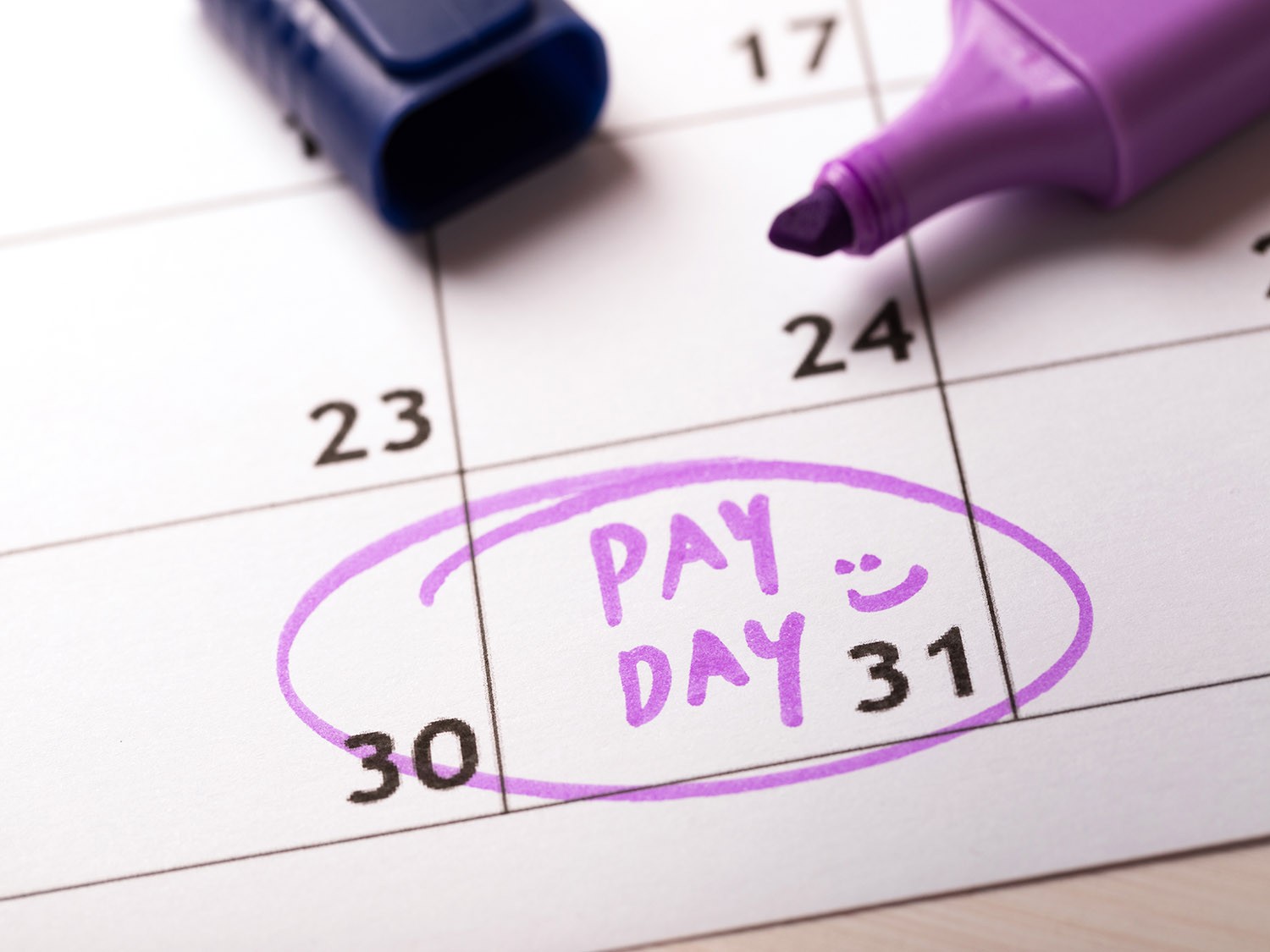 Calendar with last day of the month circled in highlighter marked "Payday" 