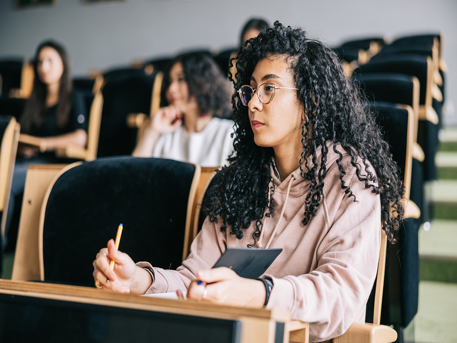 Girl sits attentively in lecture