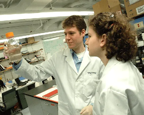 Two student researchers working in a lab