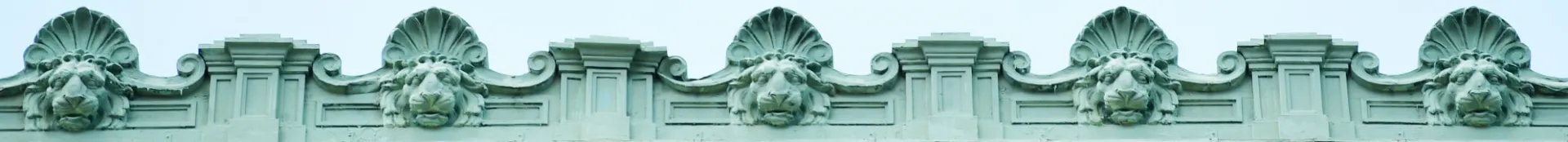 Columbia University campus architecture featuring lion head mascot. 