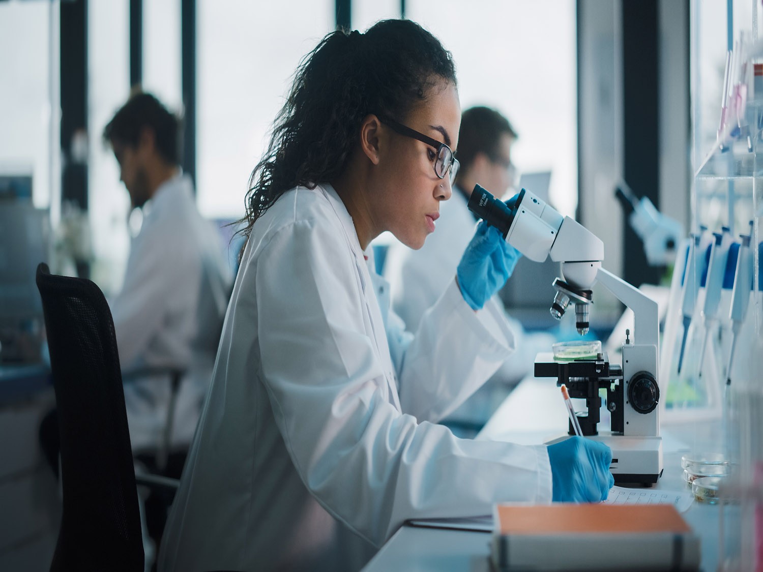 Lab research student worker using equipment.