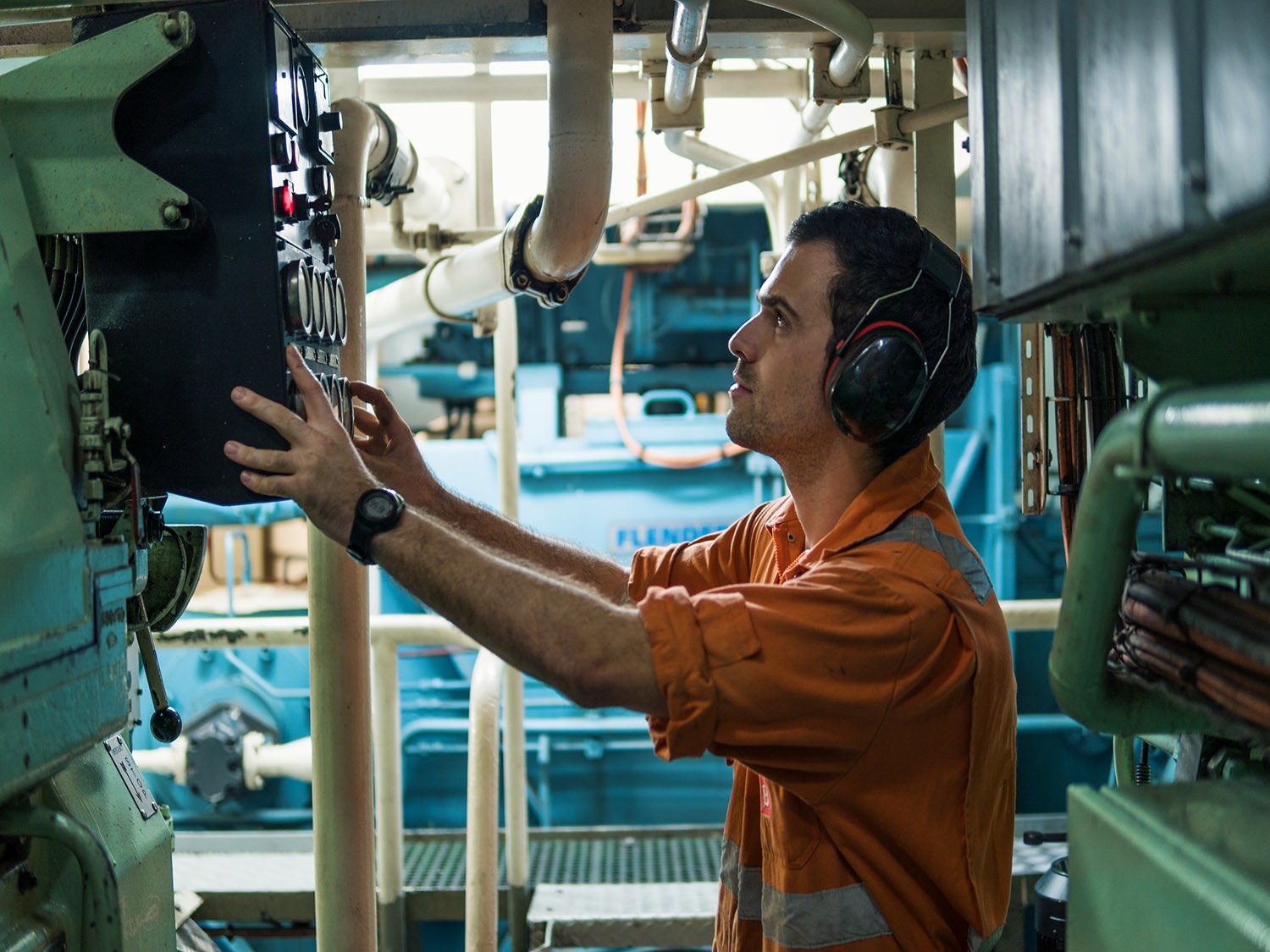 Military employee works on machinery.