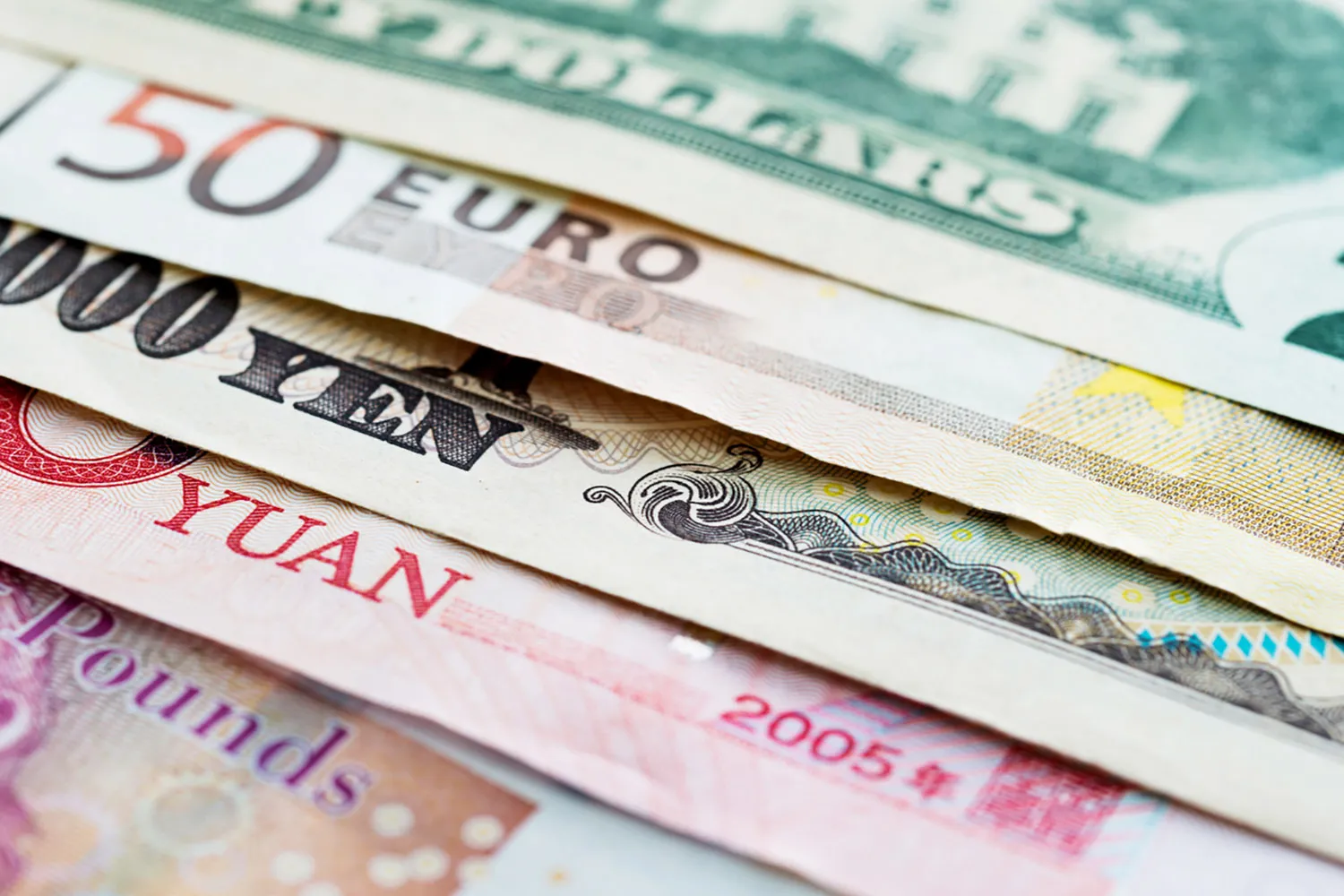 Closeup image of different bills of currency
