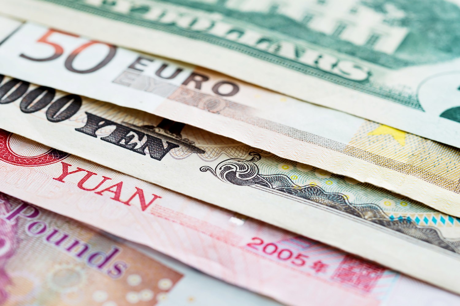 Closeup image of different bills of currency